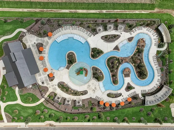 a view of a swimming pool with outdoor seating