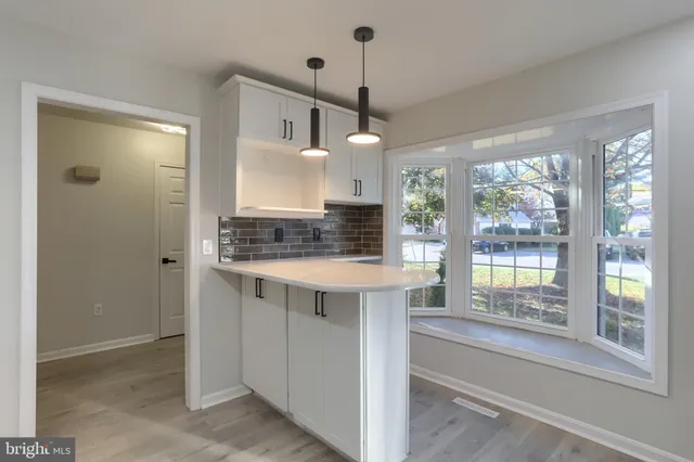 a view of kitchen with granite countertop stove and large window