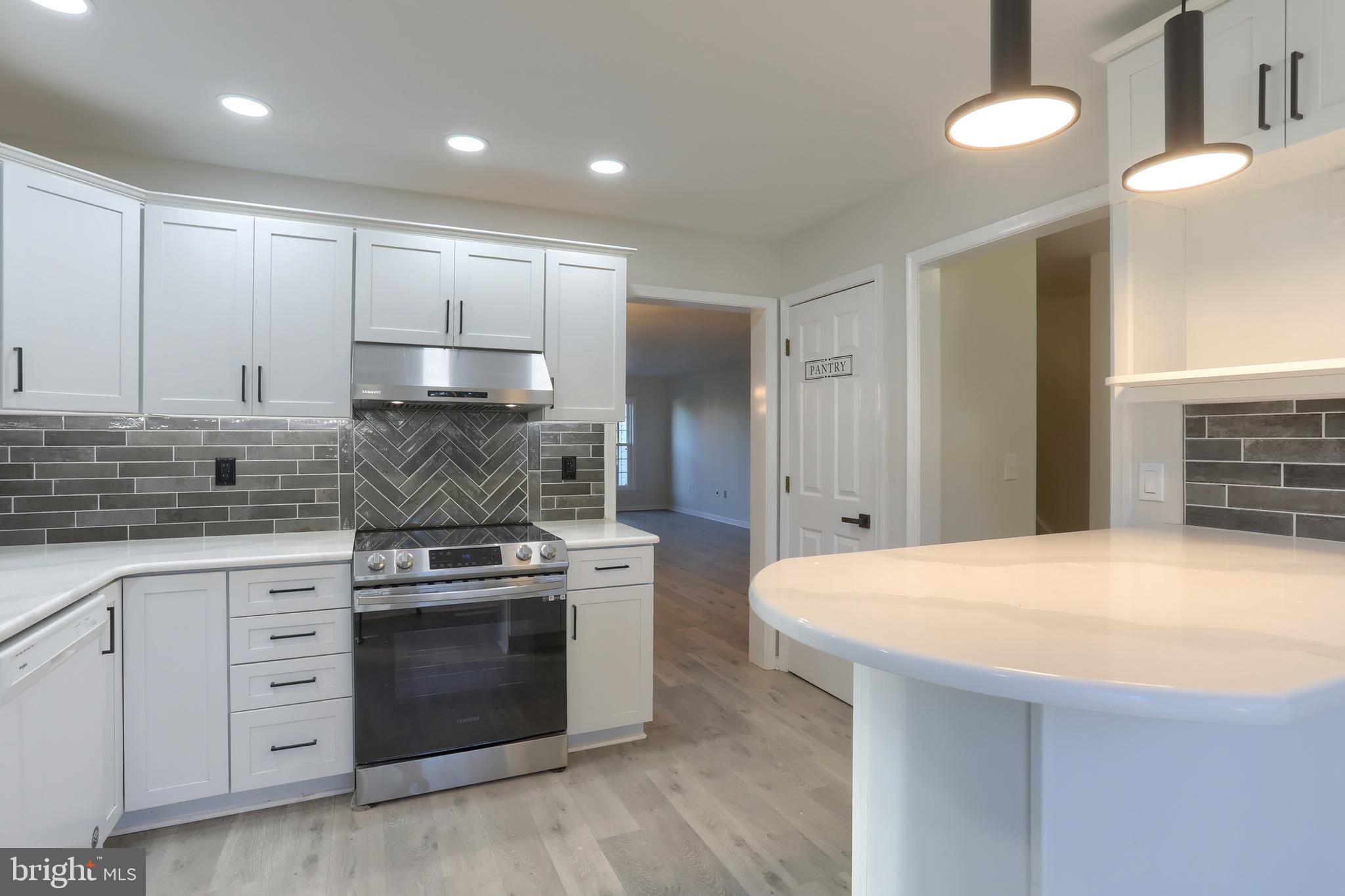 2065 Raleigh Road, Unit B Hummelstown, PA 17036 - Photo 12 of 40 a kitchen with stainless steel appliances granite countertop a stove a sink and a refrigerator