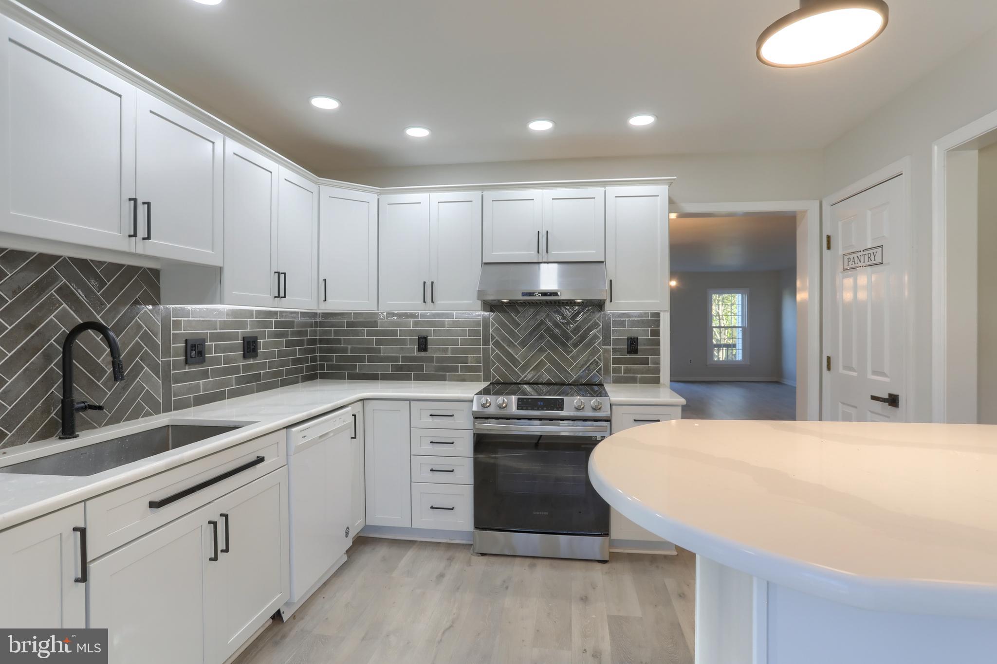 2065 Raleigh Road, Unit B Hummelstown, PA 17036 - Photo 13 of 40 a kitchen with stainless steel appliances granite countertop a sink stove and refrigerator