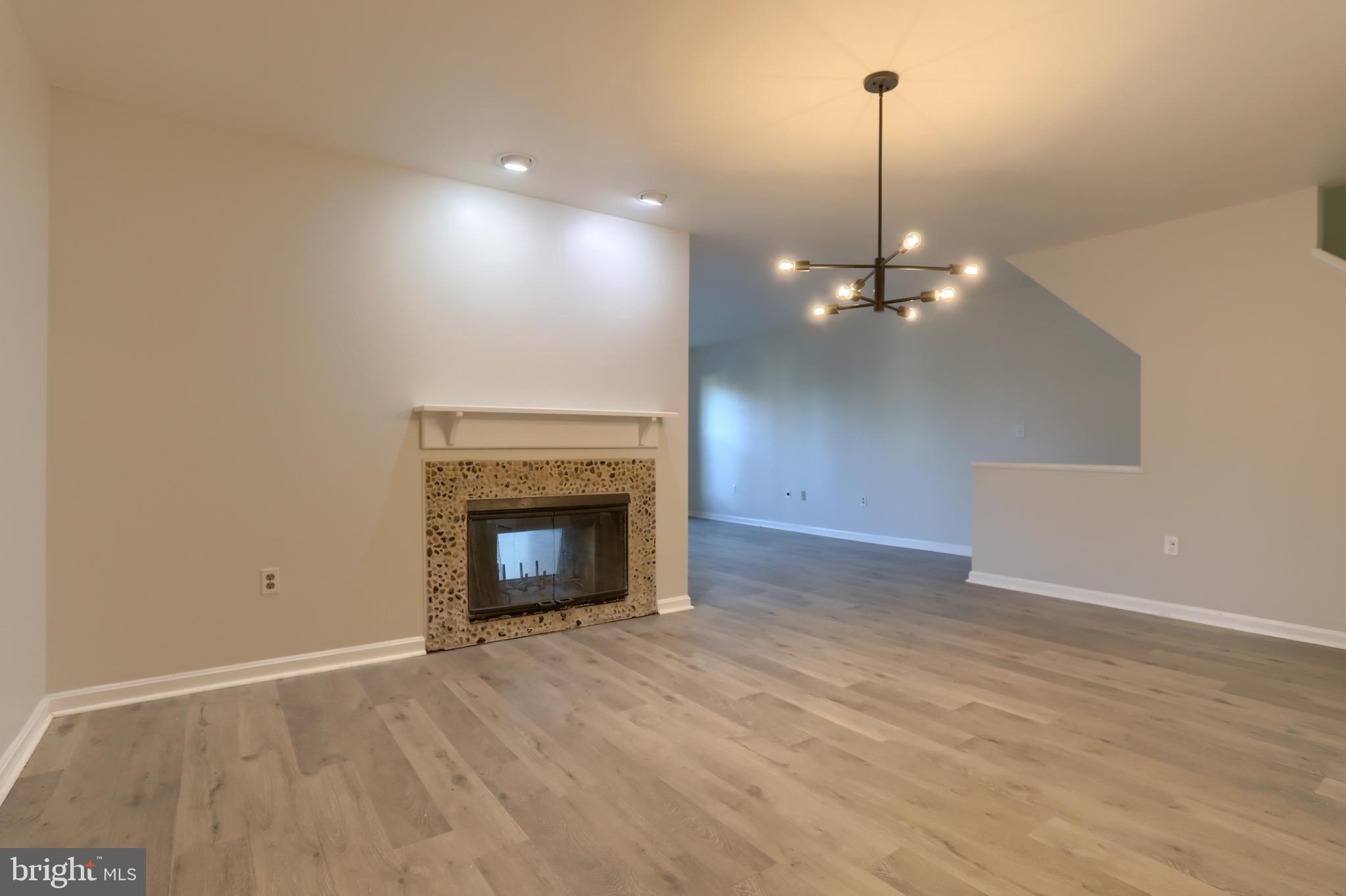 2065 Raleigh Road, Unit B Hummelstown, PA 17036 - Photo 16 of 40 a view of an empty room with wooden floor fireplace and a window
