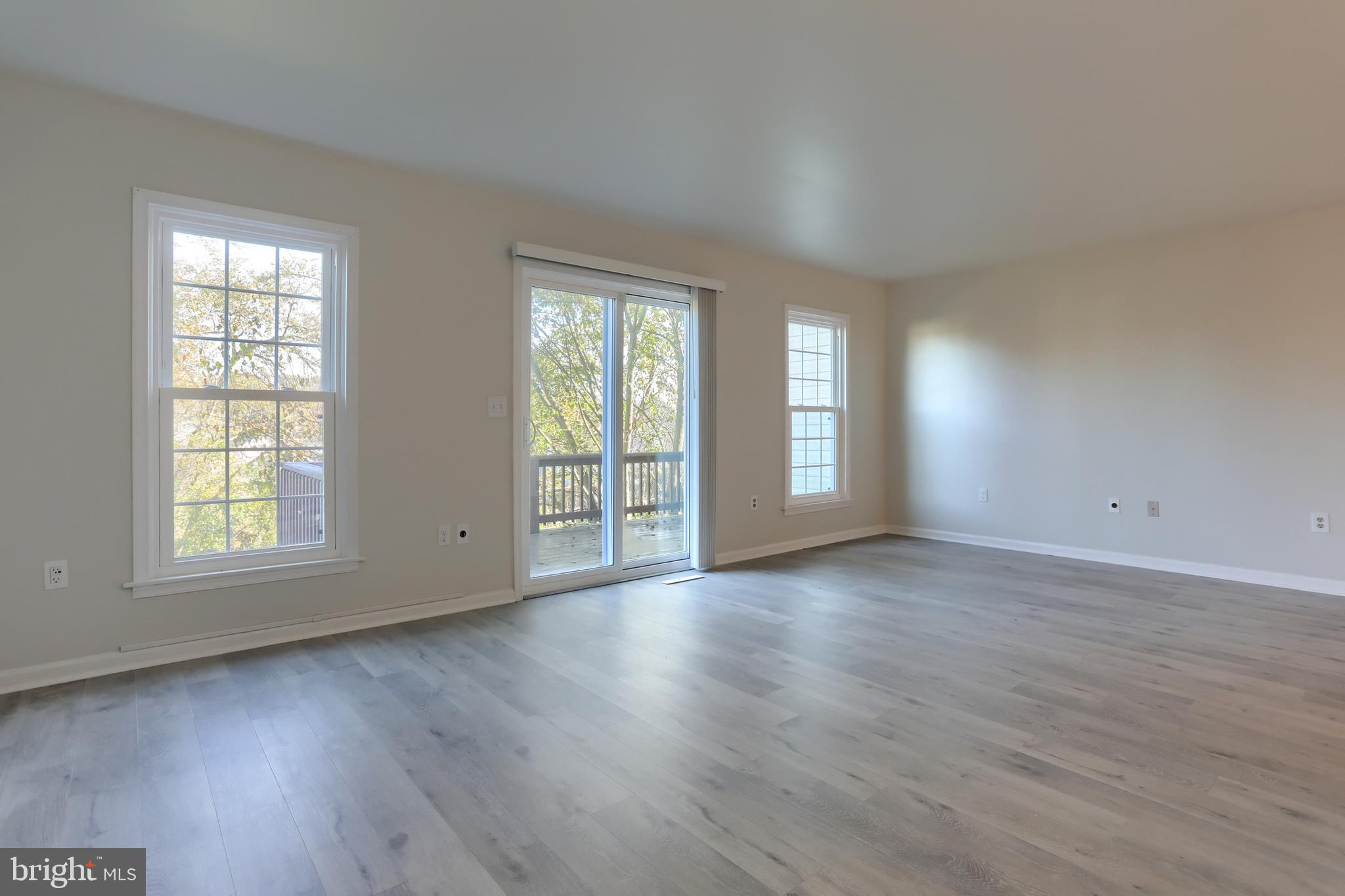 2065 Raleigh Road, Unit B Hummelstown, PA 17036 - Photo 20 of 40 an empty room with wooden floor and windows