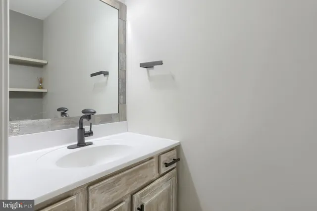 a bathroom with a sink and mirror