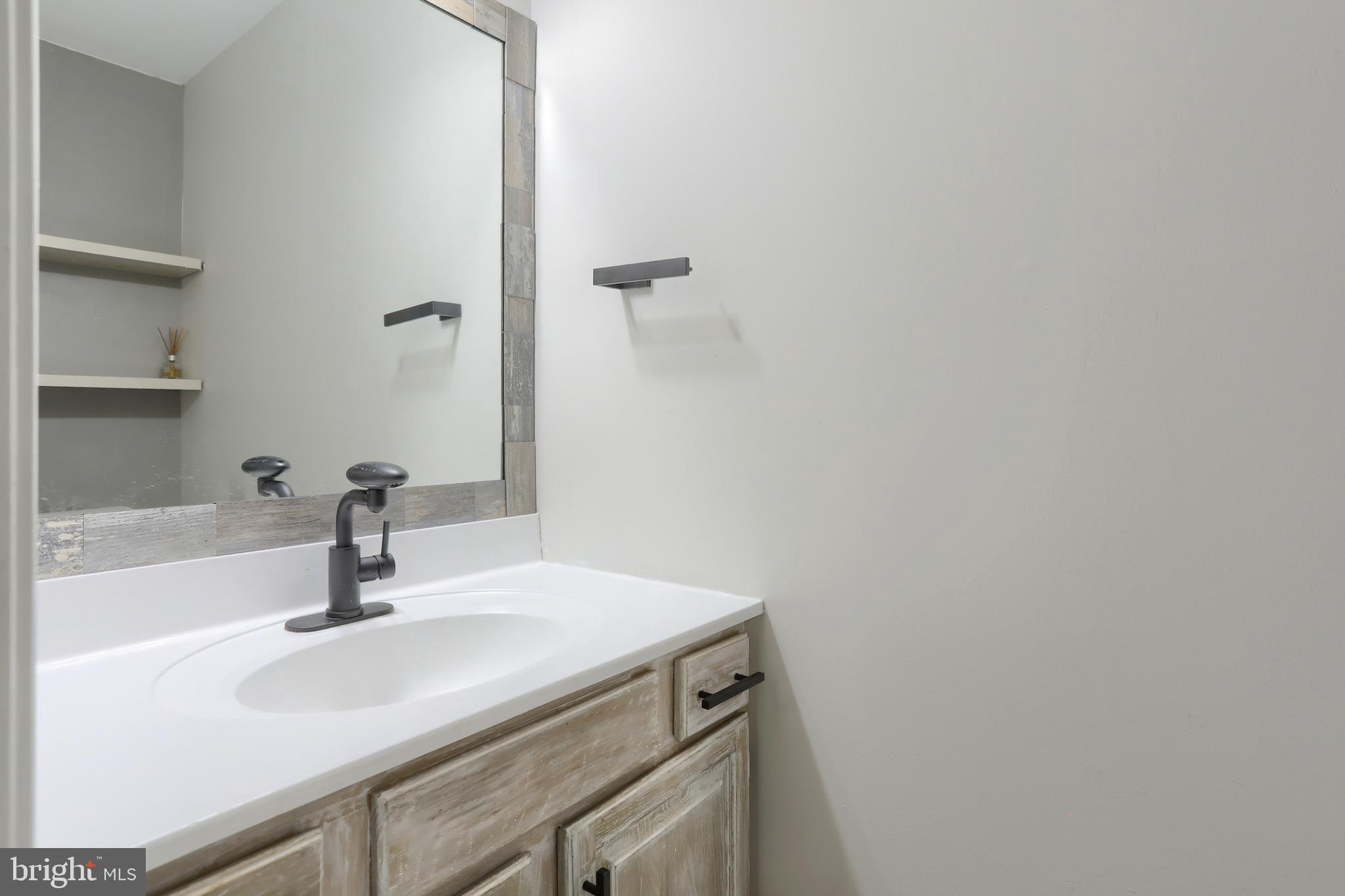 2065 Raleigh Road, Unit B Hummelstown, PA 17036 - Photo 21 of 40 a bathroom with a sink and mirror