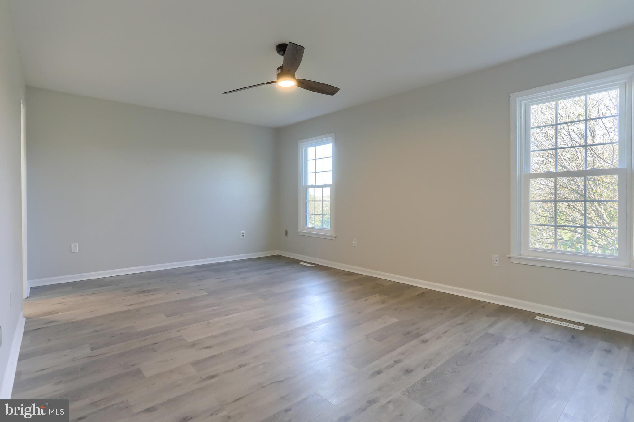 2065 Raleigh Road, Unit B Hummelstown, PA 17036 - Photo 22 of 40 an empty room with wooden floor chandelier and windows