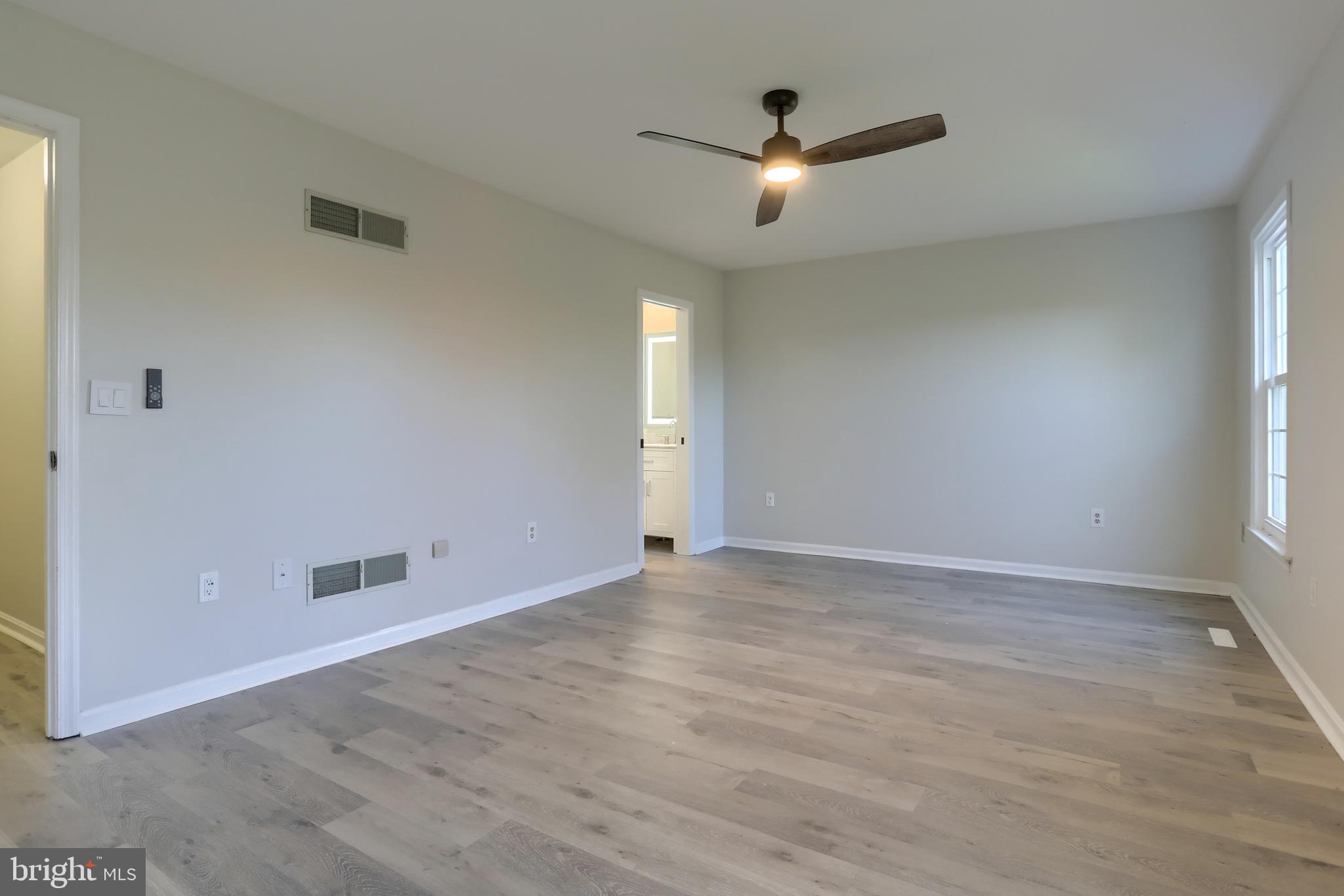 2065 Raleigh Road, Unit B Hummelstown, PA 17036 - Photo 23 of 40 wooden floor in an empty room with a window