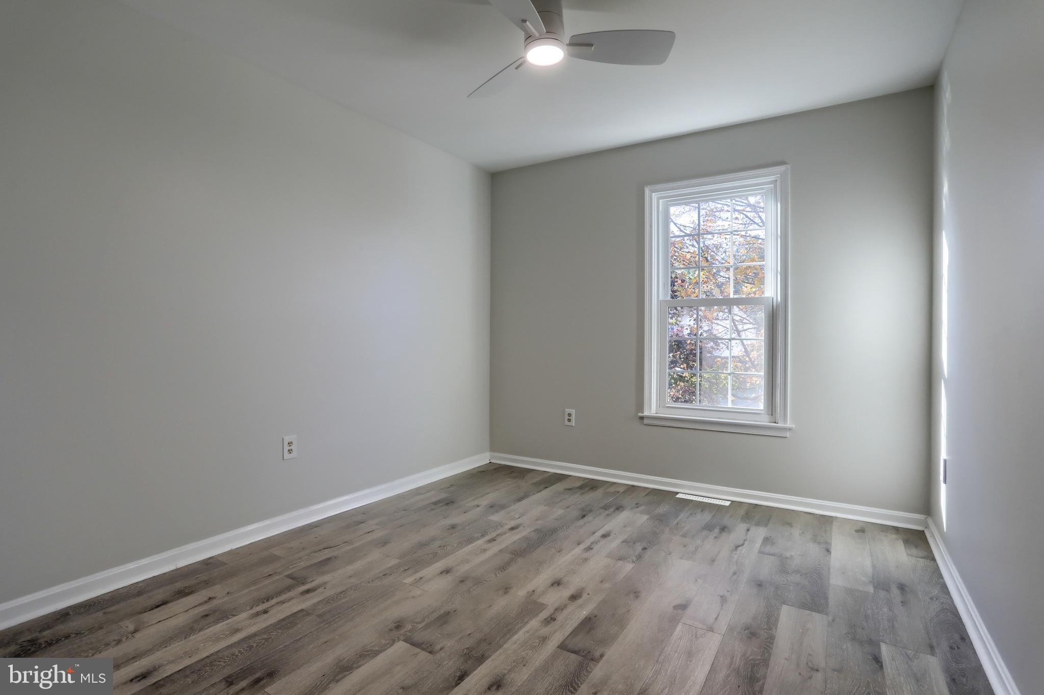 2065 Raleigh Road, Unit B Hummelstown, PA 17036 - Photo 28 of 40 an empty room with wooden floor and windows