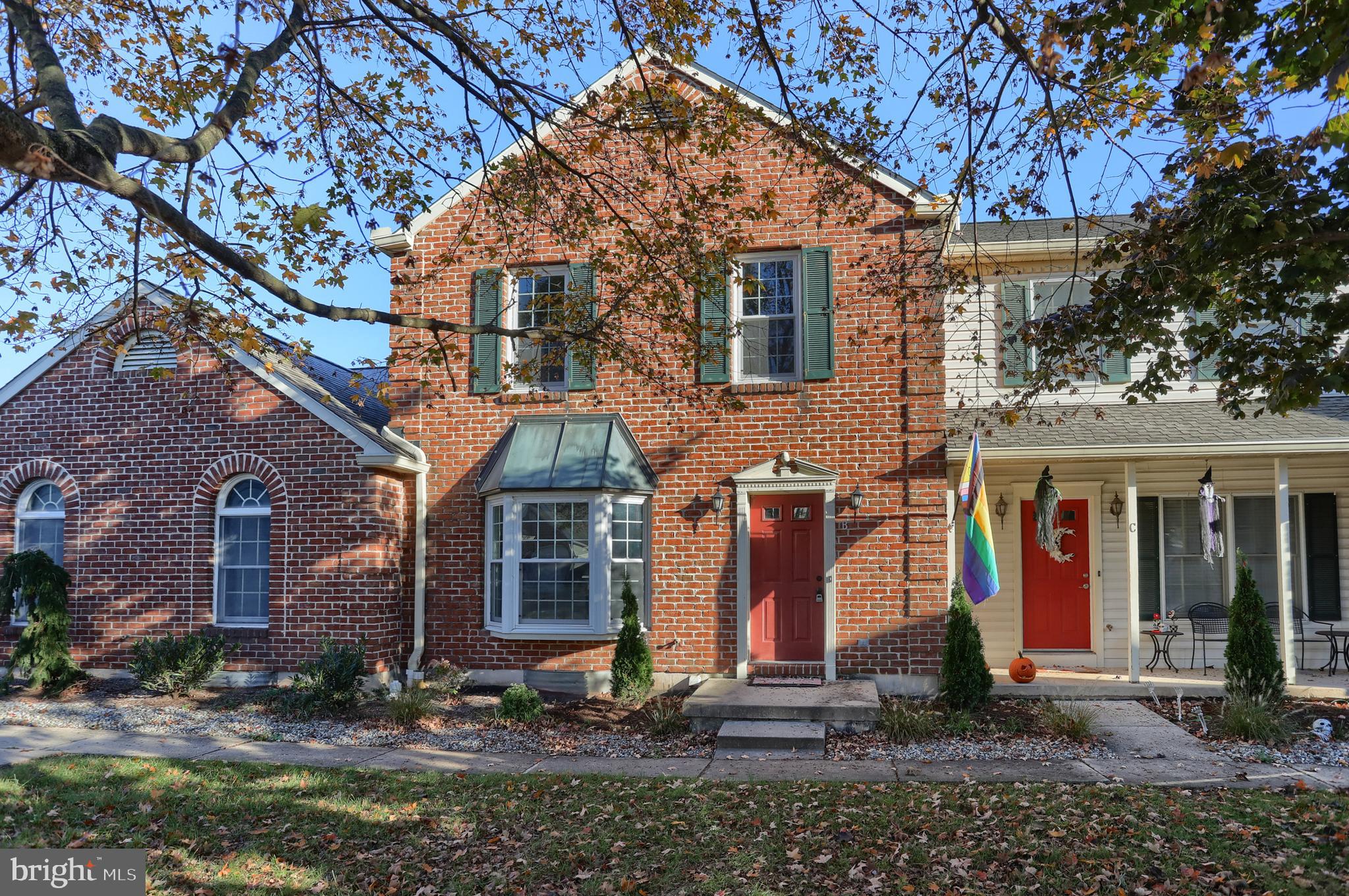 2065 Raleigh Road, Unit B Hummelstown, PA 17036 - Photo 5 of 40 a view of a white house with large windows next to a road