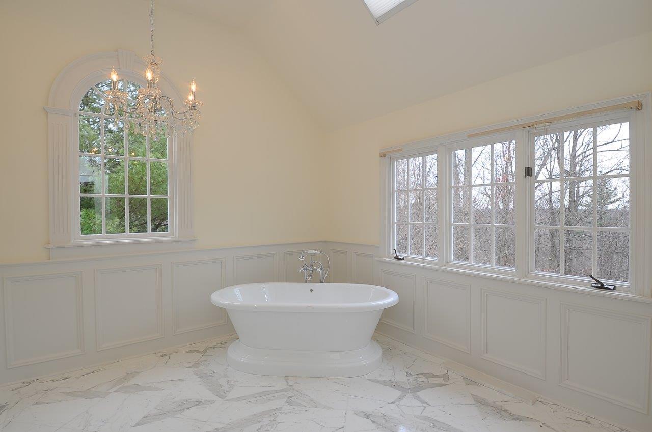 1185 Smith Ridge Road New Canaan, CT 06840 - Photo 14 of 17 a bathroom with a sink toilet a mirror and window