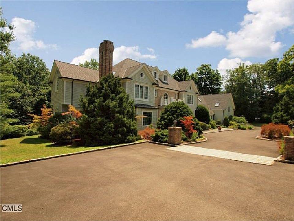 1185 Smith Ridge Road New Canaan, CT 06840 - Photo 17 of 17 front view of a house with a couple of cars parked in front of it
