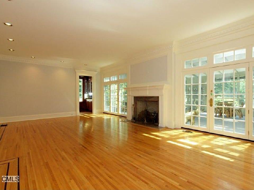 1185 Smith Ridge Road New Canaan, CT 06840 - Photo 3 of 17 a view of empty room with wooden floor and fireplace