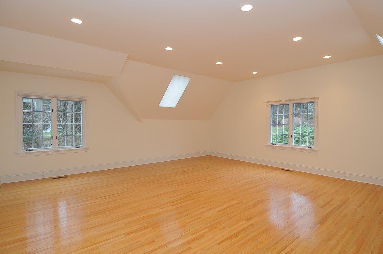 1185 Smith Ridge Road New Canaan, CT 06840 - Photo 10 of 17 an empty room with wooden floor and windows