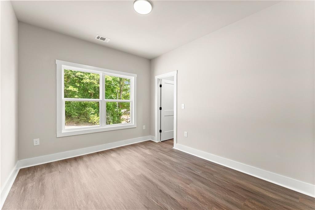 43 Anderson Street Jefferson, GA 30549 - Photo 24 of 45 an empty room with wooden floor and windows