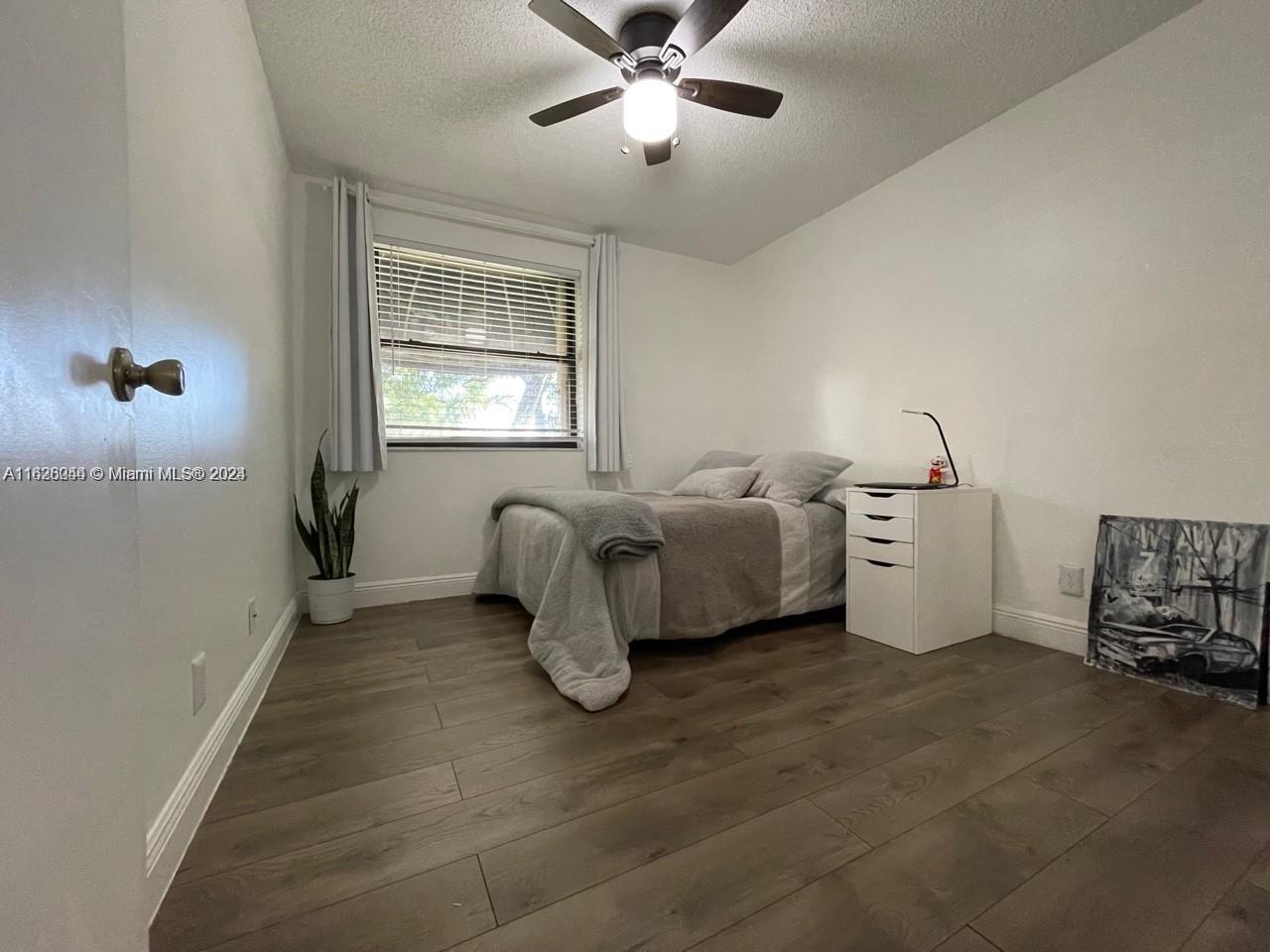 501 Racquet Club Road, Unit 63 Weston, FL 33326 - Photo 12 of 14 a living room with furniture and a window