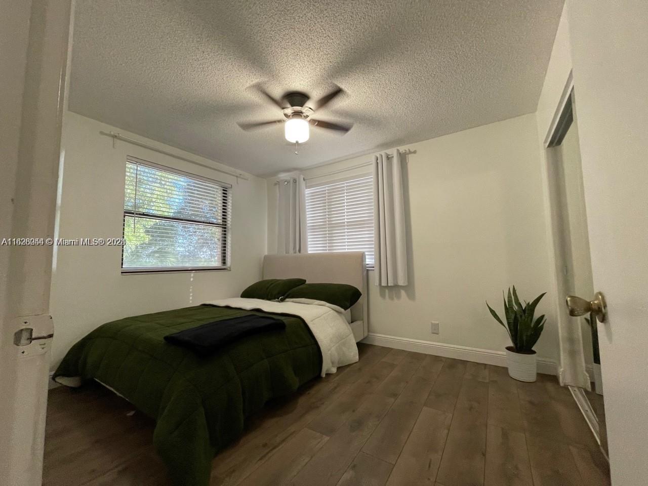 501 Racquet Club Road, Unit 63 Weston, FL 33326 - Photo 14 of 14 a bedroom with a bed and a window