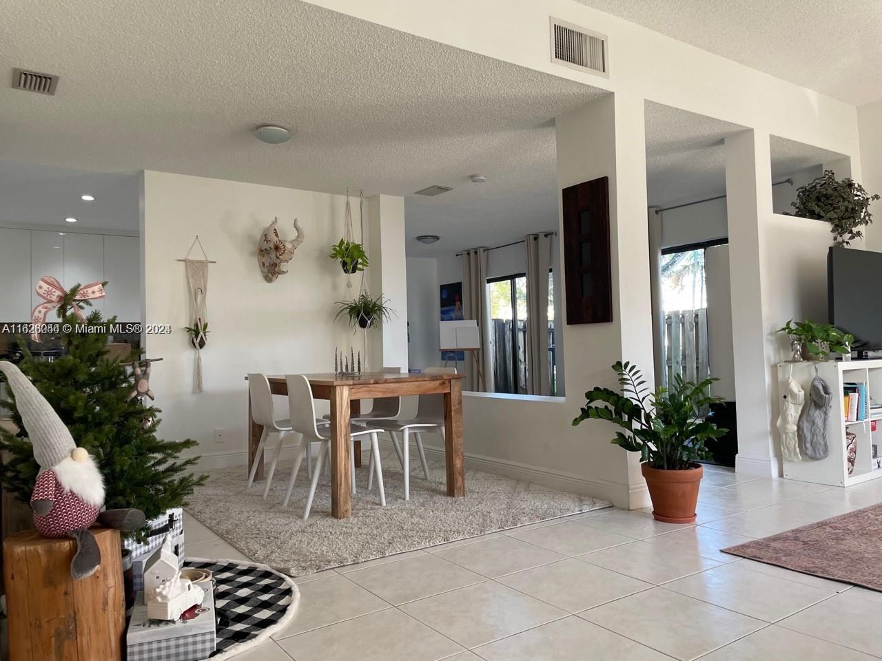 501 Racquet Club Road, Unit 63 Weston, FL 33326 - Photo 6 of 14 a dining room with furniture and wooden floor