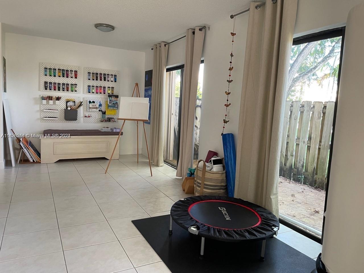 501 Racquet Club Road, Unit 63 Weston, FL 33326 - Photo 9 of 14 a living room with furniture and a large window