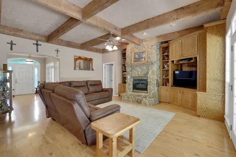 a living room with furniture and a chandelier