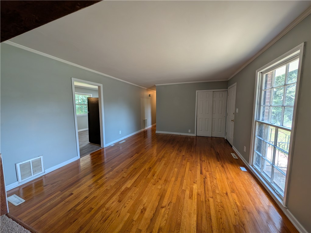 203 Glendale Road Anderson, SC 29624 - Photo 5 of 20 Natural light illuminates the lustrous hardwood flooring throughout this spacious living area.