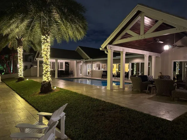 a view of a house with swimming pool and sitting area