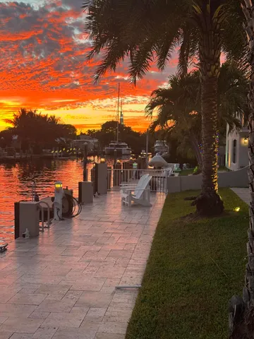 a view of a balcony with chairs and potted plants