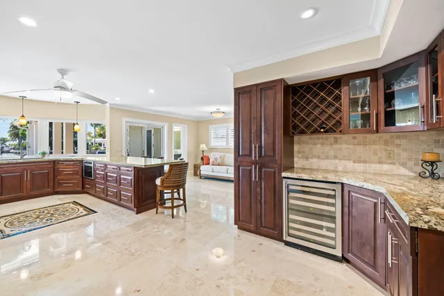 a large kitchen with stainless steel appliances granite countertop a stove a sink and a granite counter tops