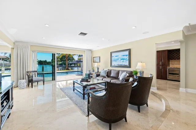 a living room with hard wood flooring and a rug