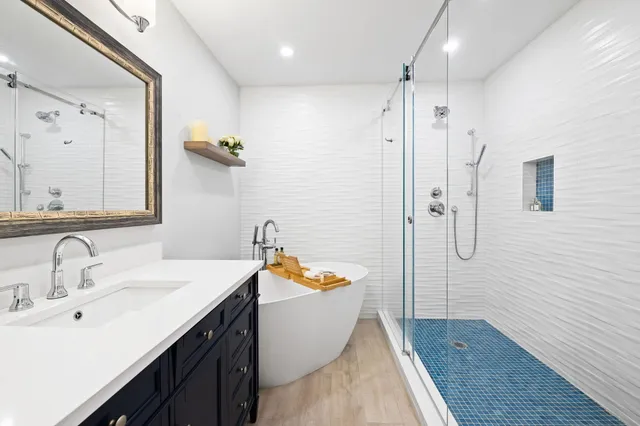 a spacious bedroom with a large bed and a chandelier