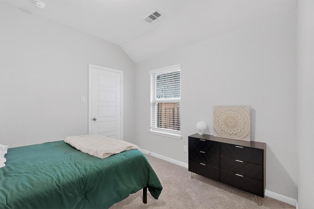 2319 Kirkstall Way Forney, TX 75126 - Photo 19 of 29 a bedroom with a bed and a window