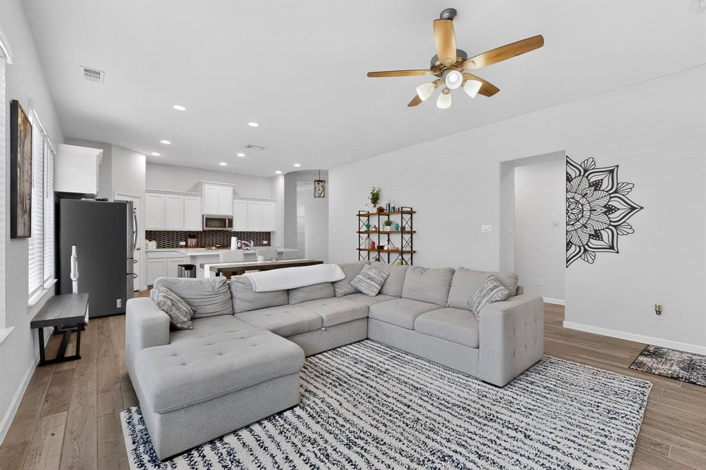 2319 Kirkstall Way Forney, TX 75126 - Photo 3 of 29 a living room with furniture or kitchen view and a chandelier