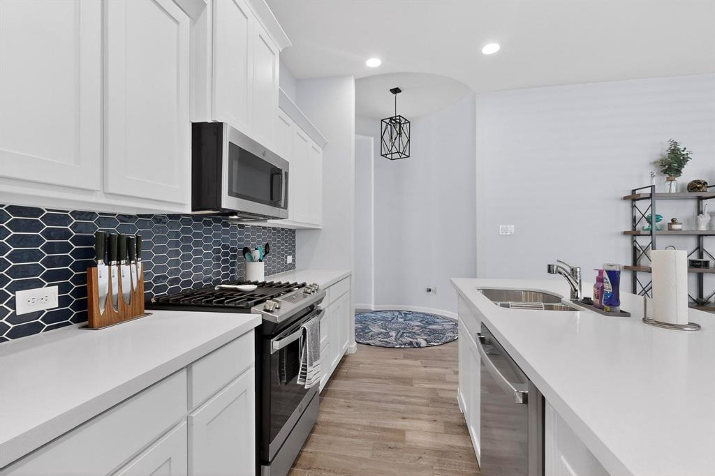 2319 Kirkstall Way Forney, TX 75126 - Photo 5 of 29 a kitchen with a sink stove and cabinets
