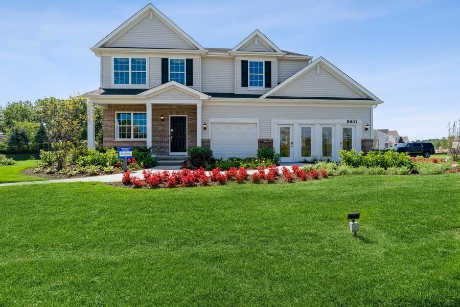 11290 Green Place Winfield, IN 46307 - Photo 12 of 27 a front view of a house with a yard and trees
