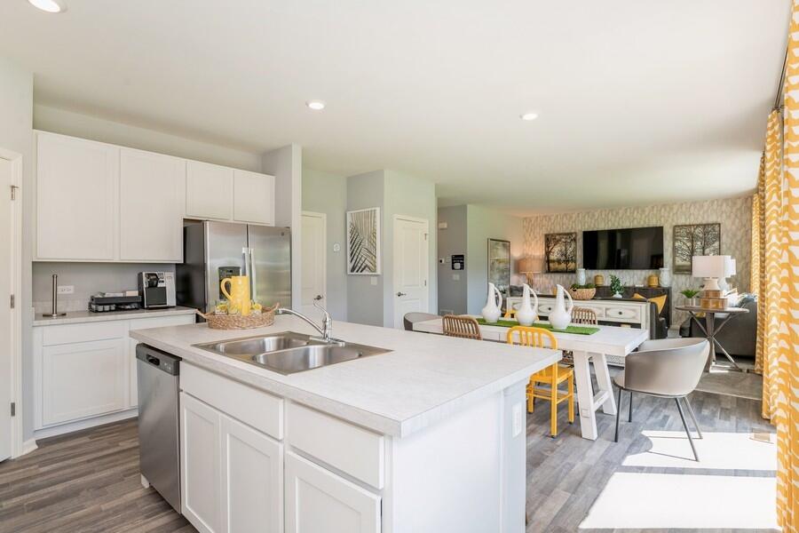 11290 Green Place Winfield, IN 46307 - Photo 15 of 27 a kitchen with a sink and chairs