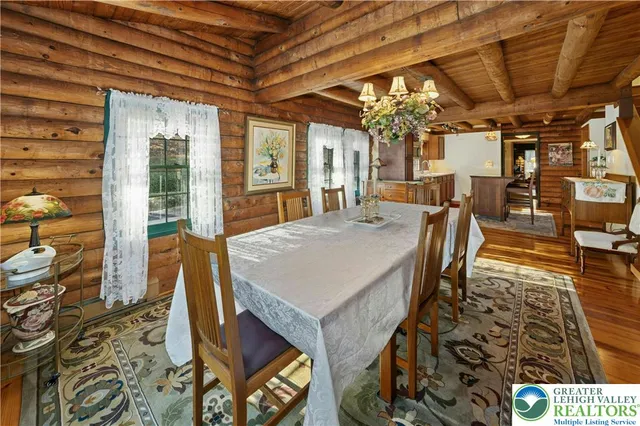 a view of a dining room with furniture wooden floor and chandelier