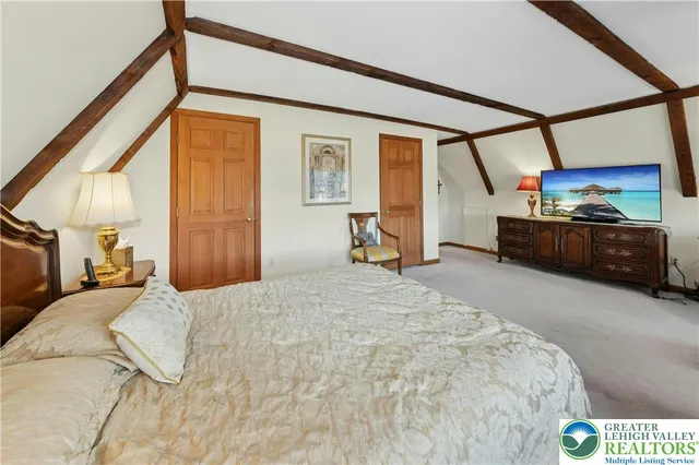 a bedroom with a bed a window and chair