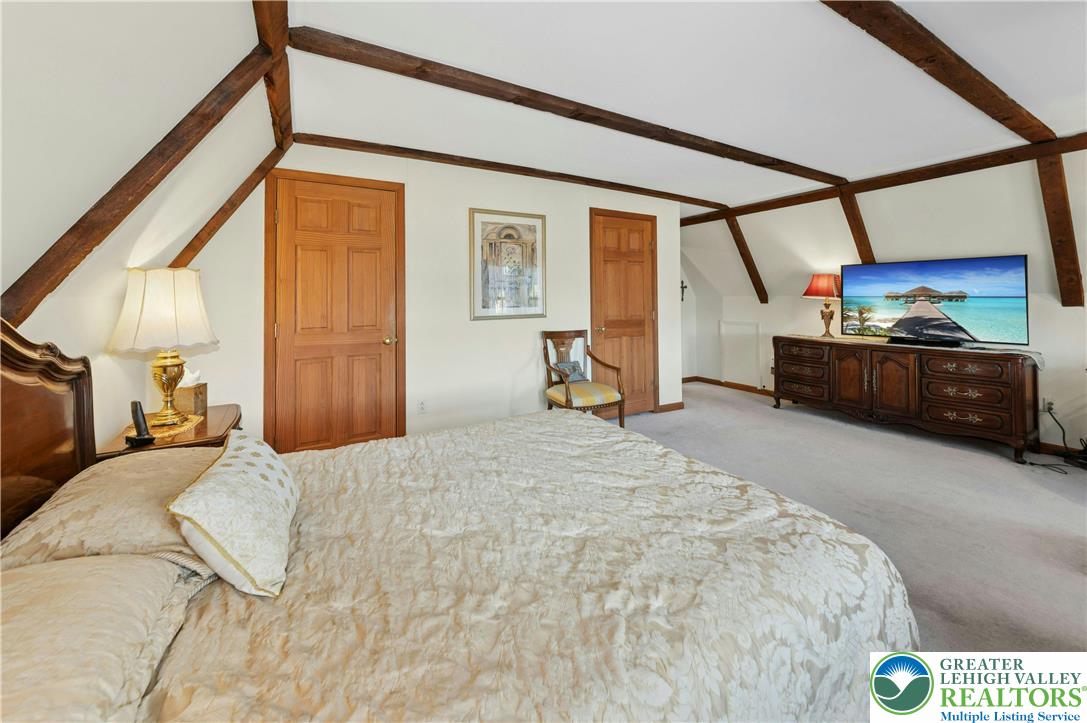 3980 Lehnenberg Road Riegelsville, PA 18077 - Photo 18 of 41 a bedroom with a bed a window and chair