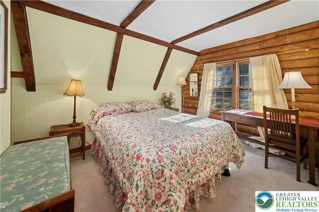 a bed sitting in a bedroom next to a window