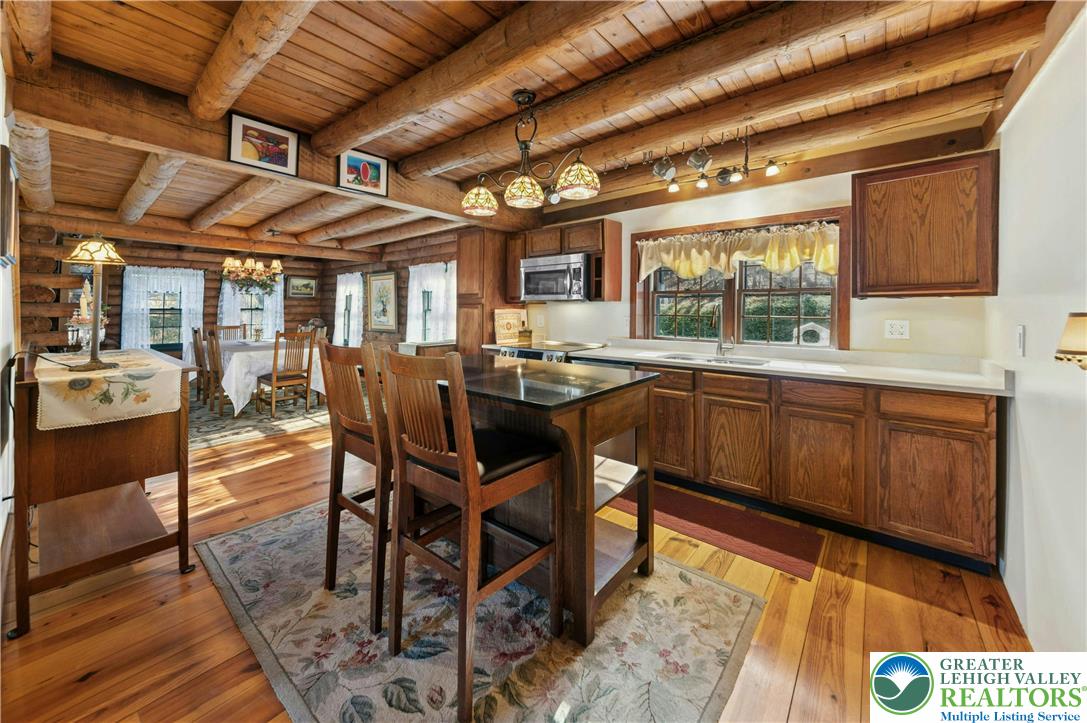 3980 Lehnenberg Road Riegelsville, PA 18077 - Photo 9 of 41 a dining hall with stainless steel appliances granite countertop a sink a stove a table and chairs