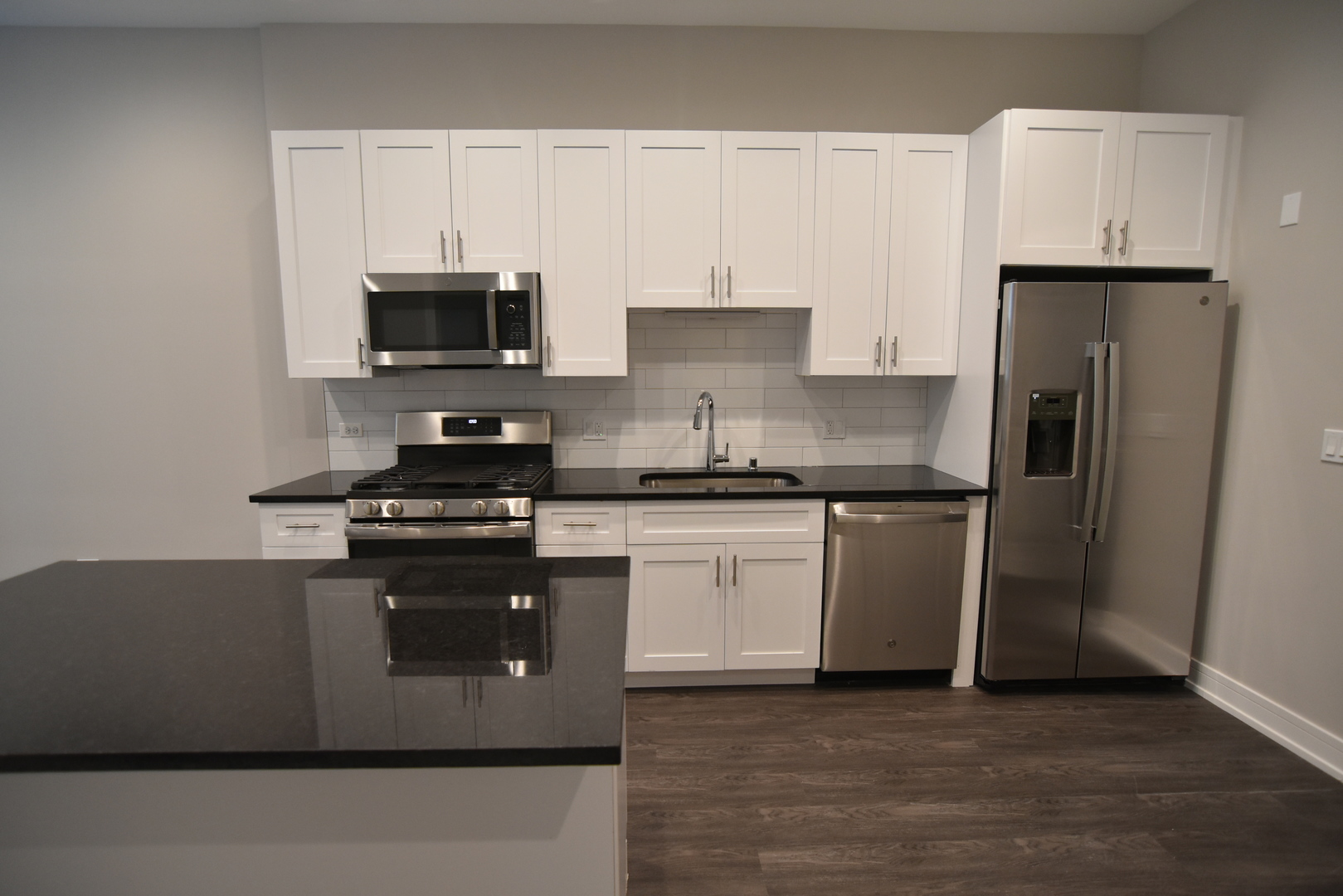 1730 West Greenleaf Avenue, Unit 102 Chicago, IL 60626 - Photo 2 of 15 a kitchen with stainless steel appliances granite countertop a stove a refrigerator and a sink