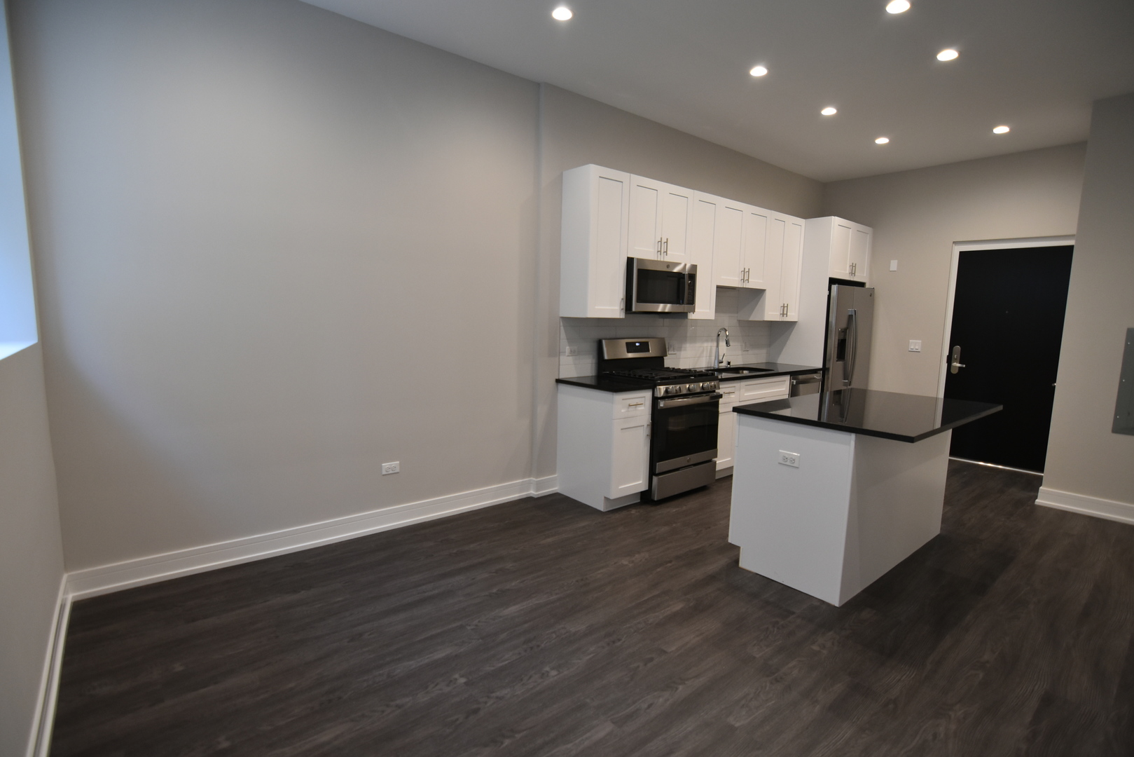 1730 West Greenleaf Avenue, Unit 102 Chicago, IL 60626 - Photo 7 of 15 a kitchen with a refrigerator and a stove top oven