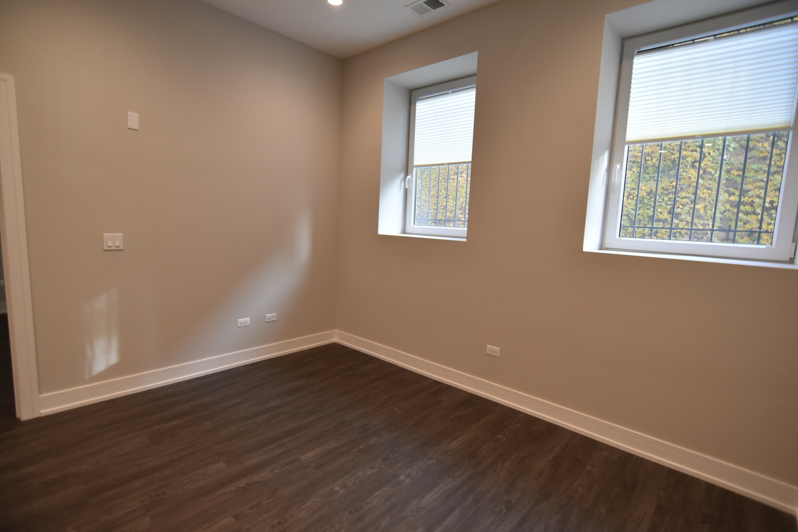1730 West Greenleaf Avenue, Unit 102 Chicago, IL 60626 - Photo 8 of 15 an empty room with wooden floor and windows
