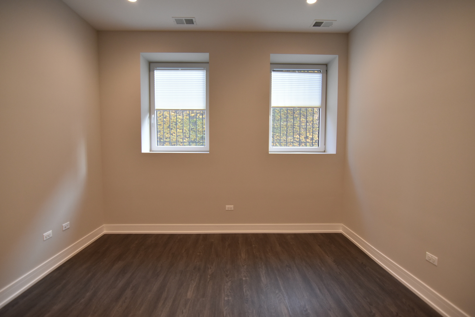 1730 West Greenleaf Avenue, Unit 102 Chicago, IL 60626 - Photo 9 of 15 wooden floor in an empty room with a window