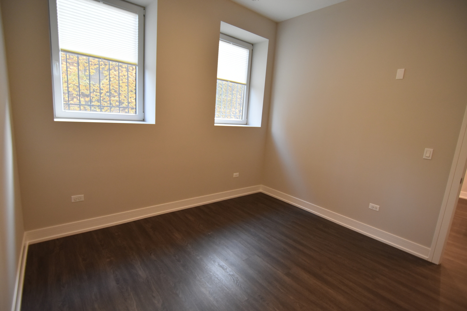 1730 West Greenleaf Avenue, Unit 102 Chicago, IL 60626 - Photo 10 of 15 an empty room with wooden floor and windows