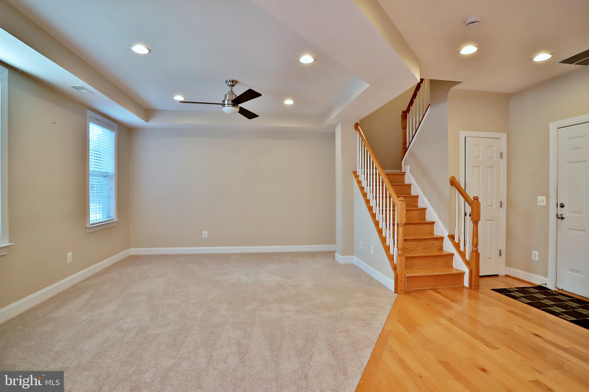 135 Fortnightly Boulevard Herndon, VA 20170 - Photo 16 of 29 a view of an empty room with wooden floor and stairs