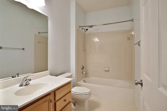 a bathroom with a sink toilet vanity and shower