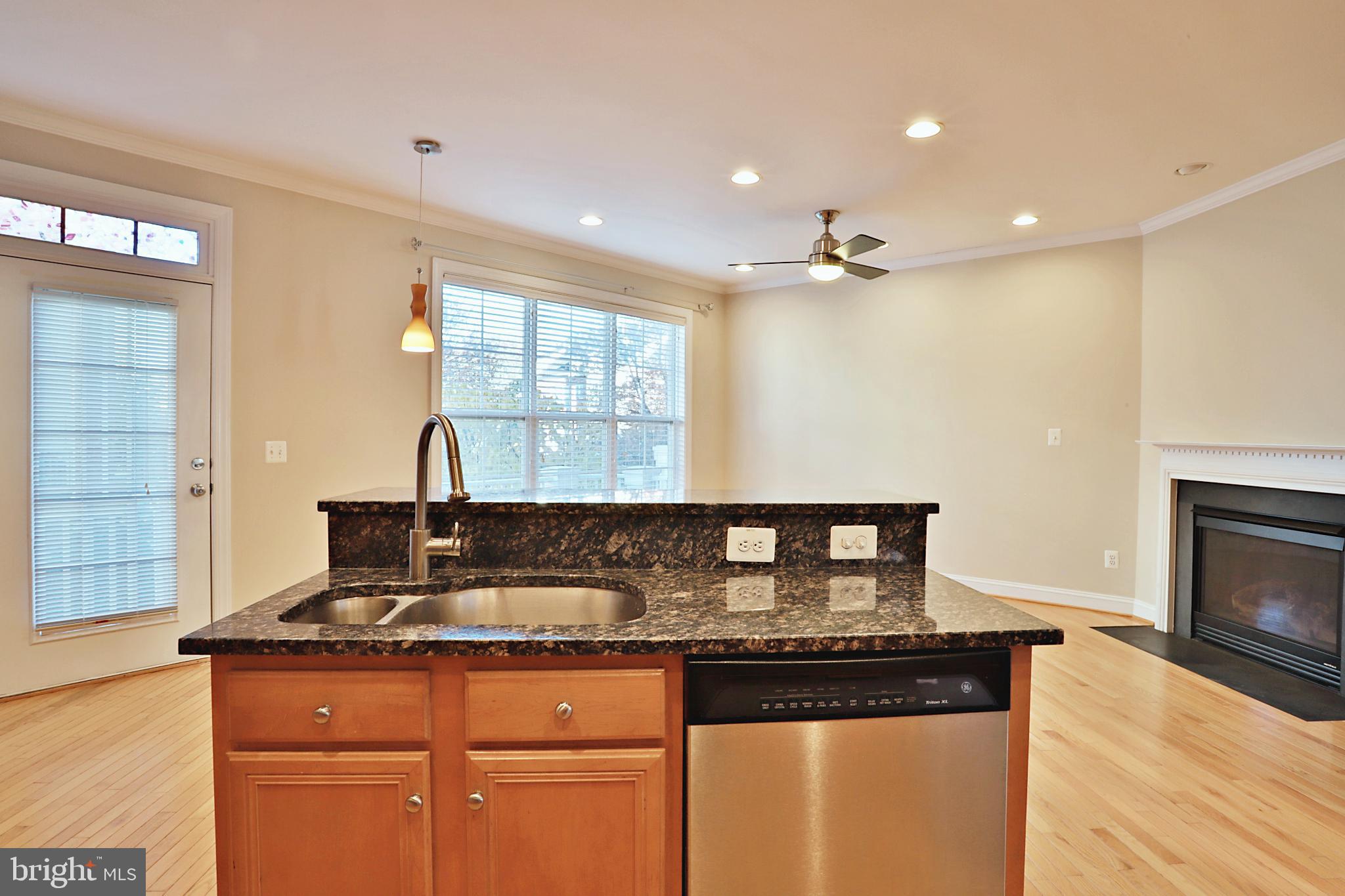 135 Fortnightly Boulevard Herndon, VA 20170 - Photo 7 of 29 a kitchen with granite countertop a stove a sink and a refrigerator