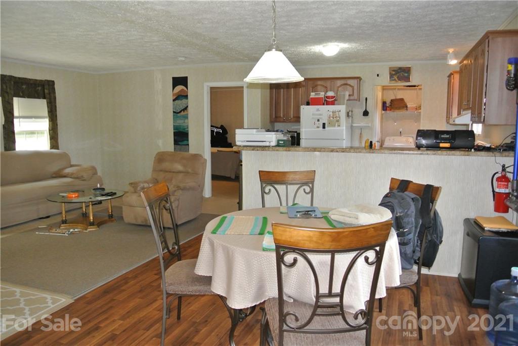 475 West V Thompson Road Rutherfordton, NC 28139 - Photo 13 of 46 a living room with furniture a table and kitchen view
