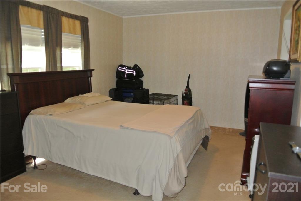 475 West V Thompson Road Rutherfordton, NC 28139 - Photo 19 of 46 a bedroom with a bed and large windows