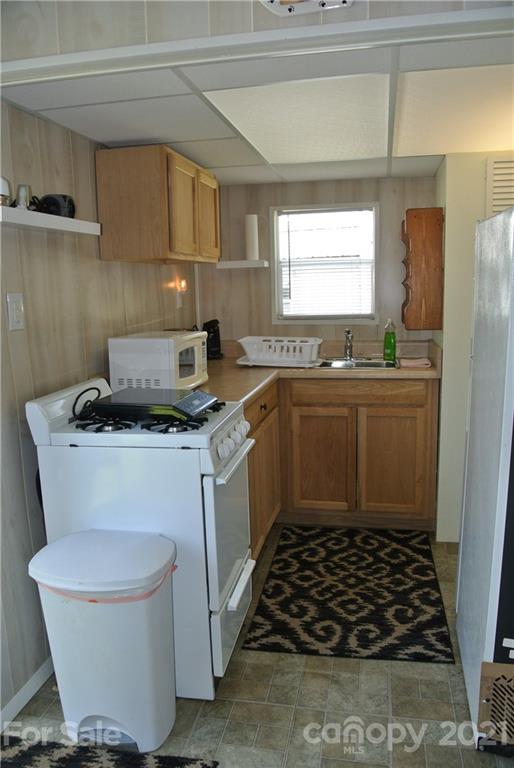 475 West V Thompson Road Rutherfordton, NC 28139 - Photo 40 of 46 a kitchen with stainless steel appliances a stove a sink and a cabinets