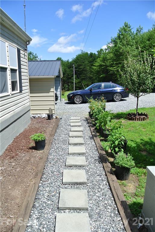 475 West V Thompson Road Rutherfordton, NC 28139 - Photo 5 of 46 a view of a backyard with potted plants